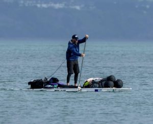 SUP'er with gear on his board