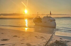 rowboat in shallow water at sunset