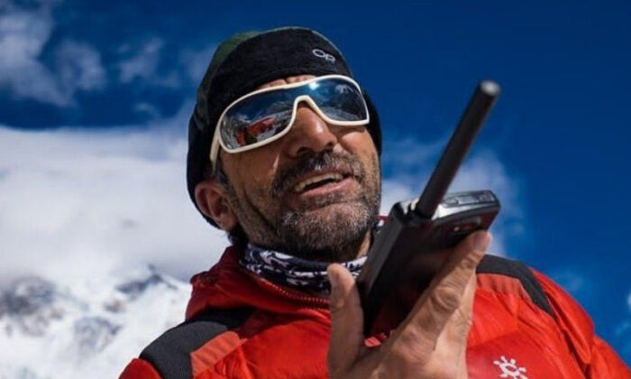 Ali with sunglasses speaking on the radio.