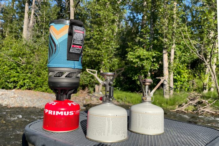 The Jetboil Flash, and integrated canister stove, is shown beside the PocketRocket Deluxe and PocketRocket 2.