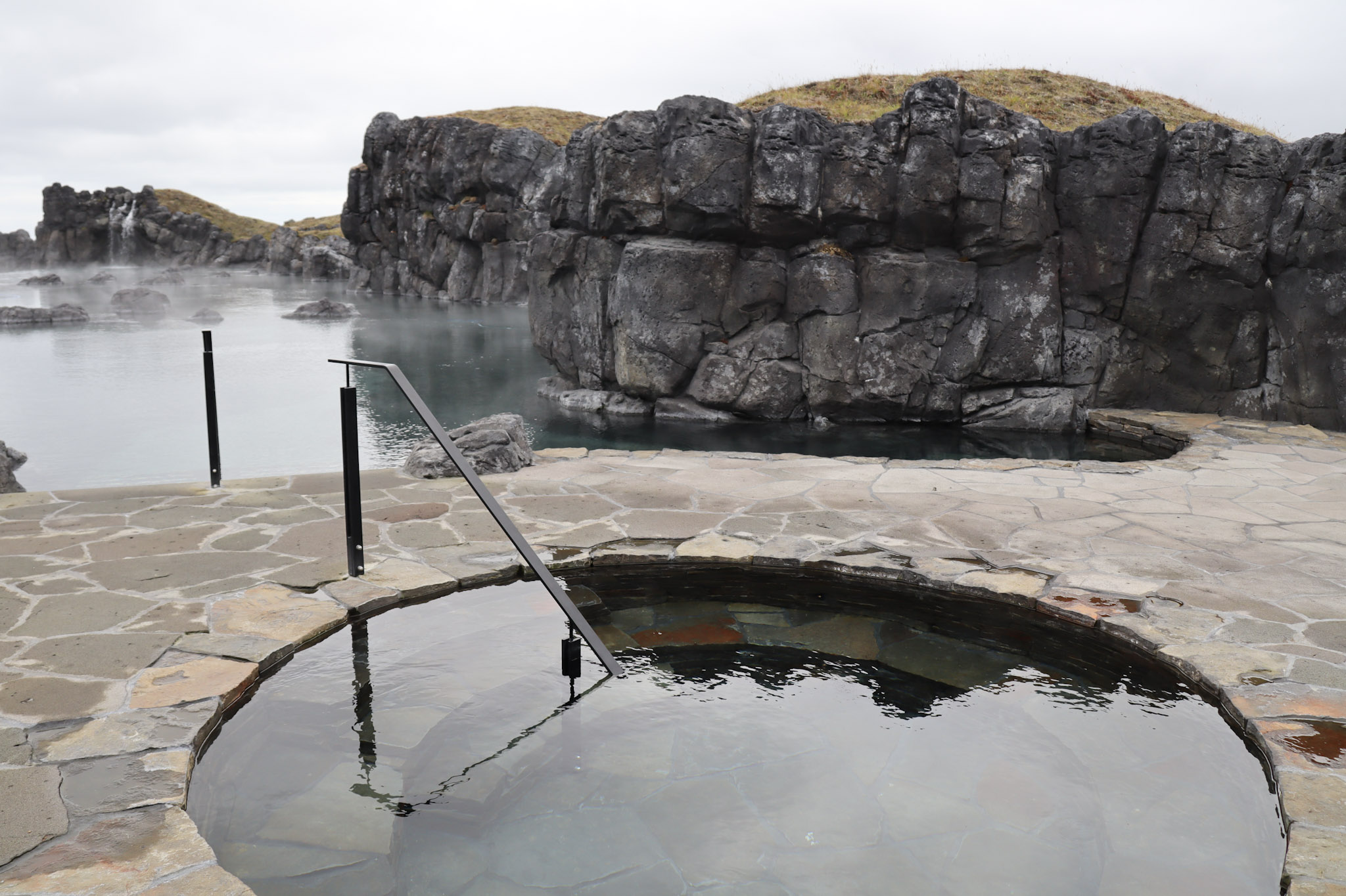 A pool of water surrounded by rocks and masonry.