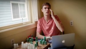 daniel winn at a table with a computer and chess set