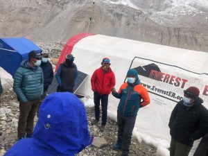 Standing people outside the medical tent at Everest Base Camp