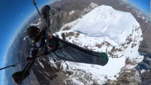 fisheye selfie of paraglider in the air