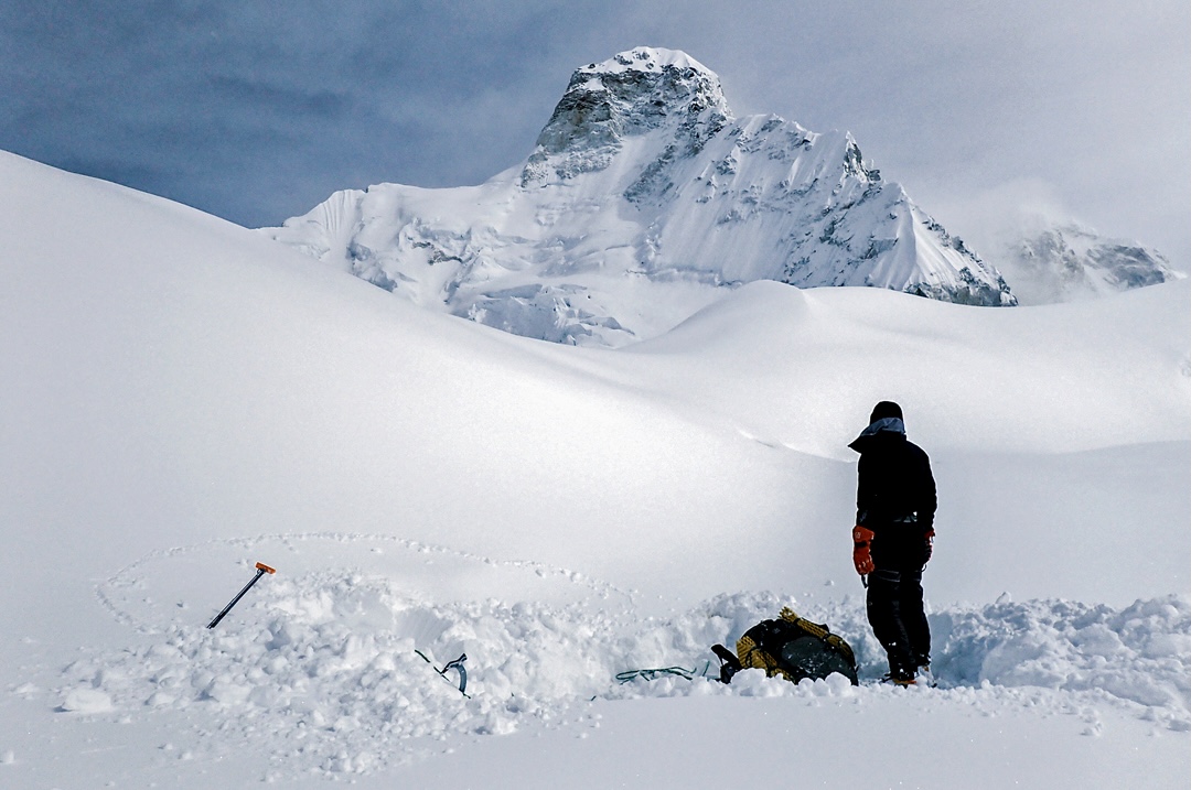 Dmitry Golovhcneko looks back at the summit of Jannu and the upper part of the French Route from the Throne glacial plateau.