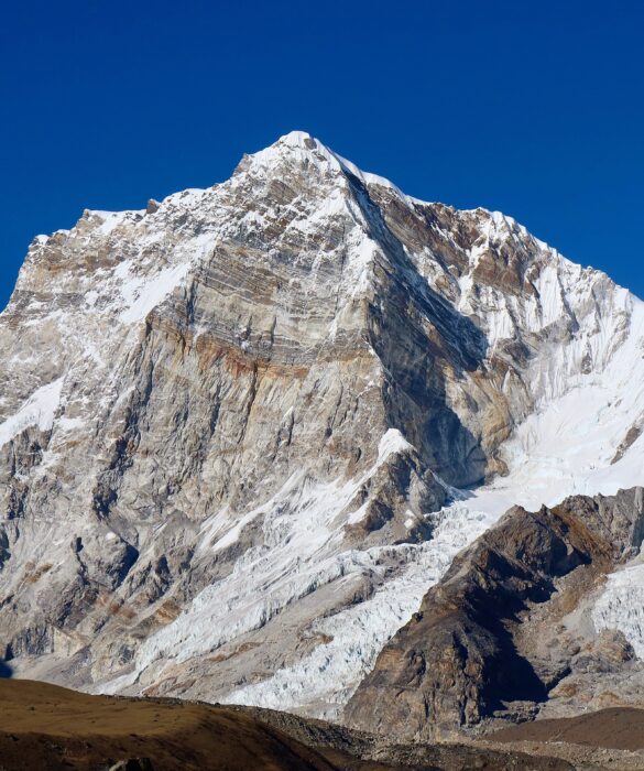 Khangri Shar as seen from the south, features a dry, vertical face with a characteristic spur. 