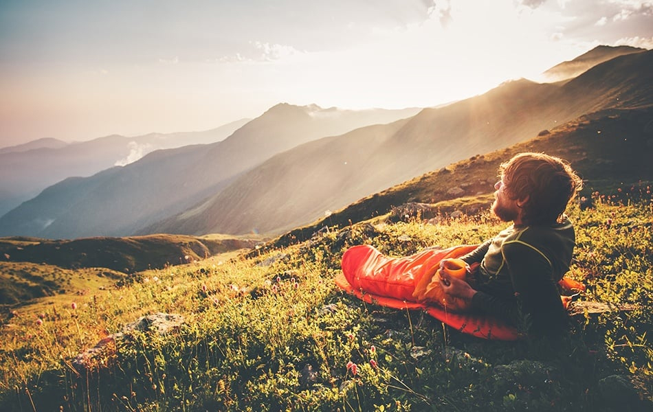 man relaxing in sleeping bag