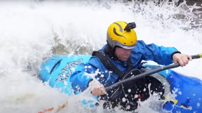 a man kayaks in intense whitewater