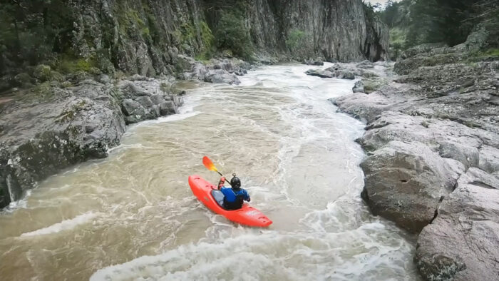 a man kayaks on a river