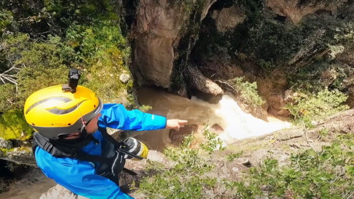 a man points down into a canyon