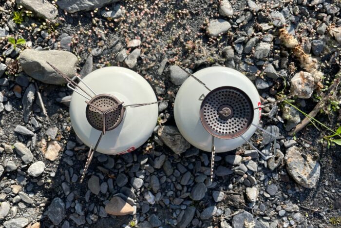 The Pocket Rocket 2 and the Pocket Rocket Deluxe are shown side by side. The Deluxe's burner is clearly larger and had a wind lip.