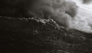b/w photo of a dark ocean wave