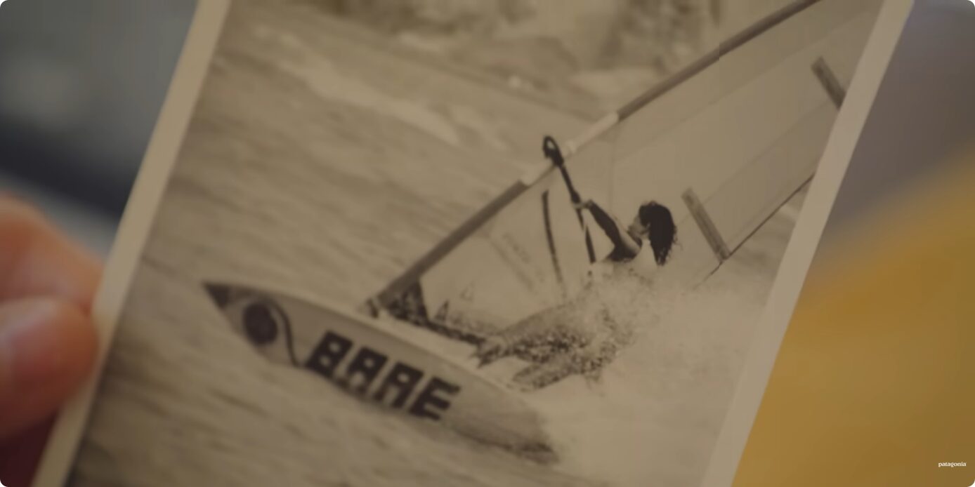 A photograph of a woman windsurfing