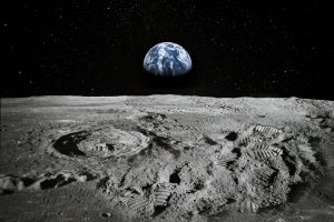 Earth viewed from the moon. The earth is visible over the horizon.