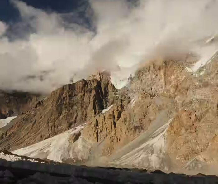 Rock walls and ragged clouds.
