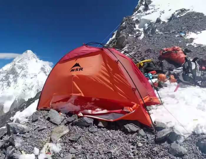A tent with some gear beside. 