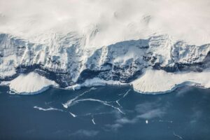 Icy cliffs meeting ocean