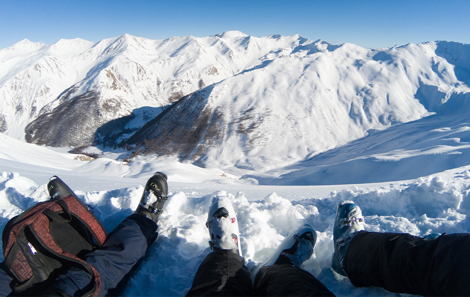 two skiers on the top of the mountain