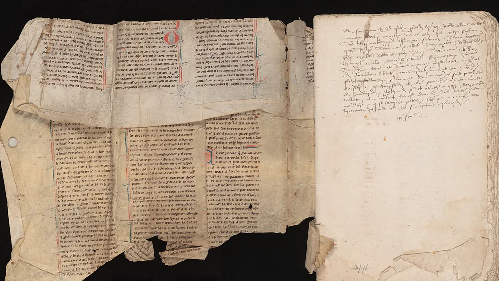 A photograph of a medieval manuscript tucked into the binding of a book.